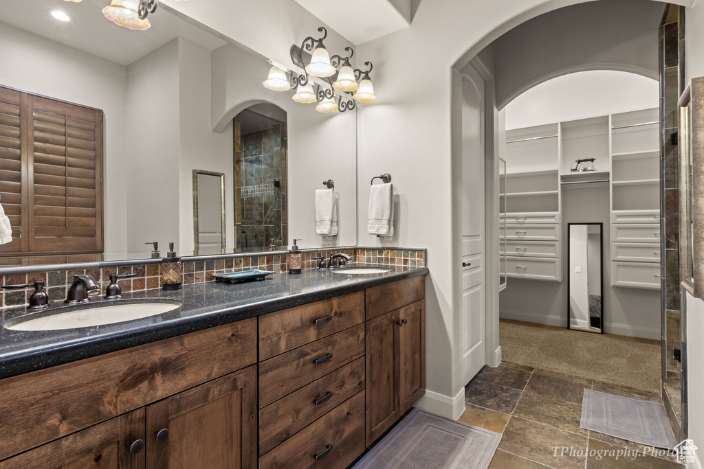 Bathroom featuring vanity, walk in shower, and tile patterned flooring