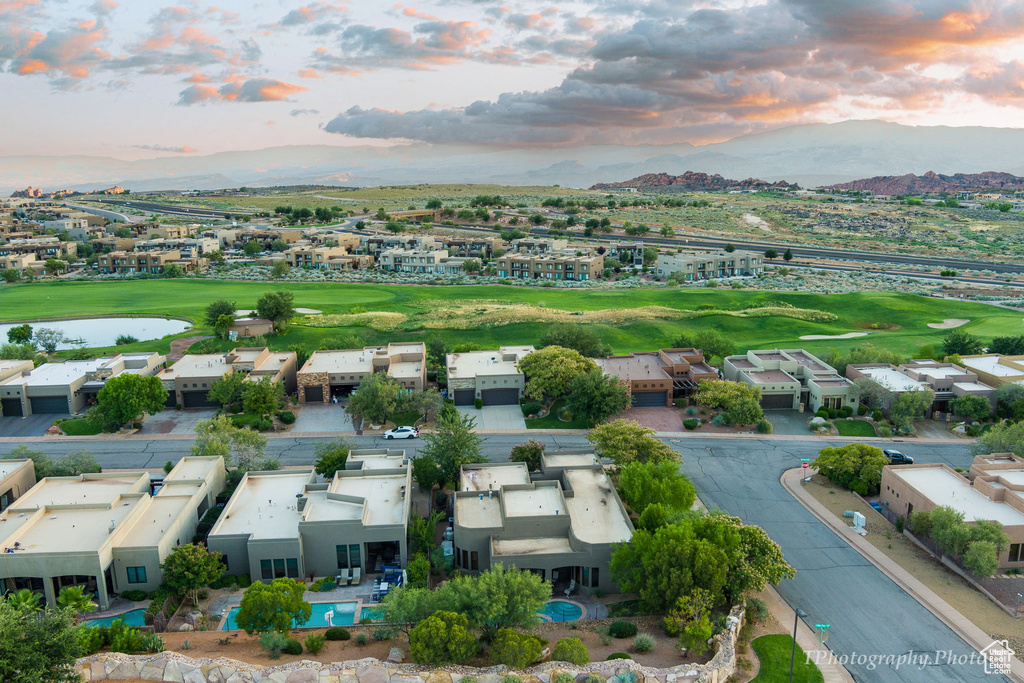 Aerial view at dusk featuring a water and mountain view