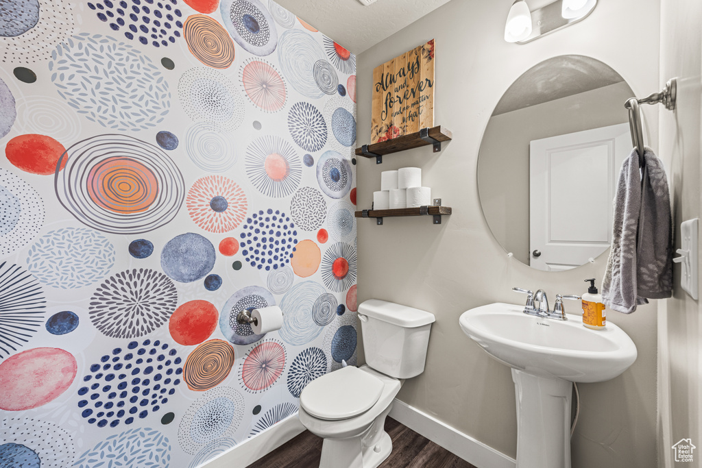 Bathroom featuring toilet and hardwood / wood-style flooring