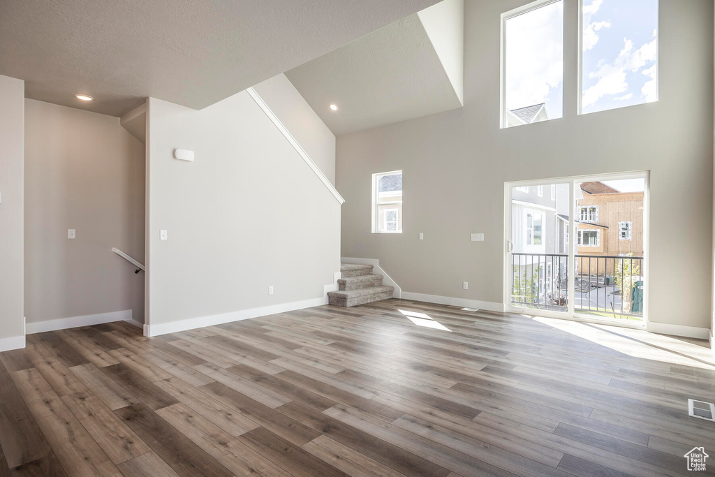 Interior space with a high ceiling and hardwood / wood-style flooring