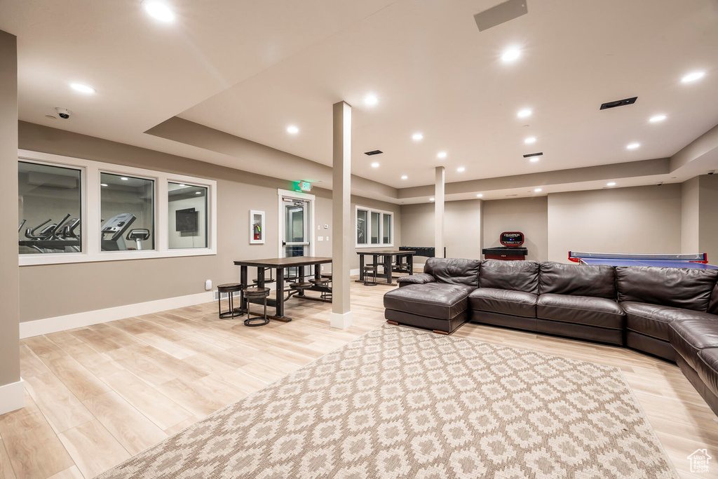 Interior space with a tray ceiling and light hardwood / wood-style floors