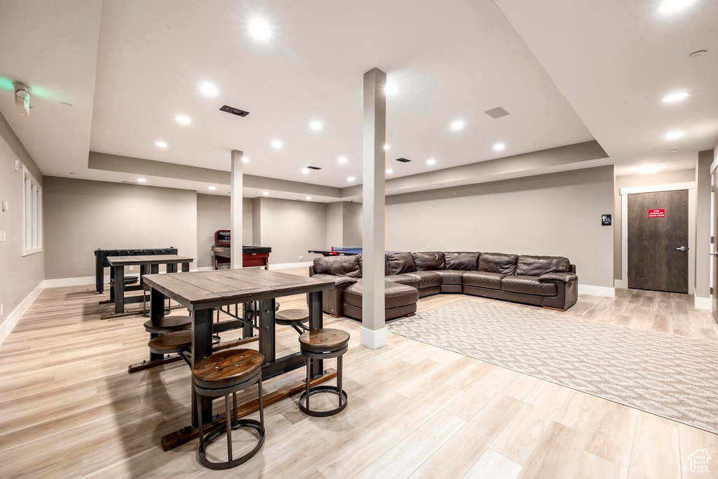 Rec room with light hardwood / wood-style flooring