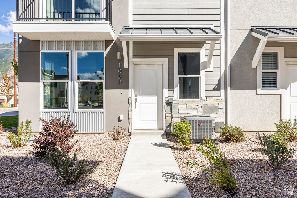 Entrance to property featuring a balcony and central air condition unit