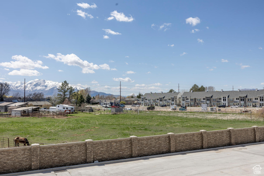 View of property's community featuring a lawn and a mountain view