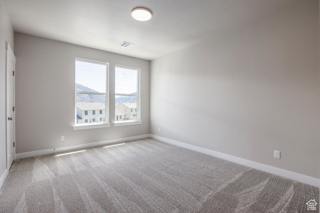 Spare room featuring carpet flooring