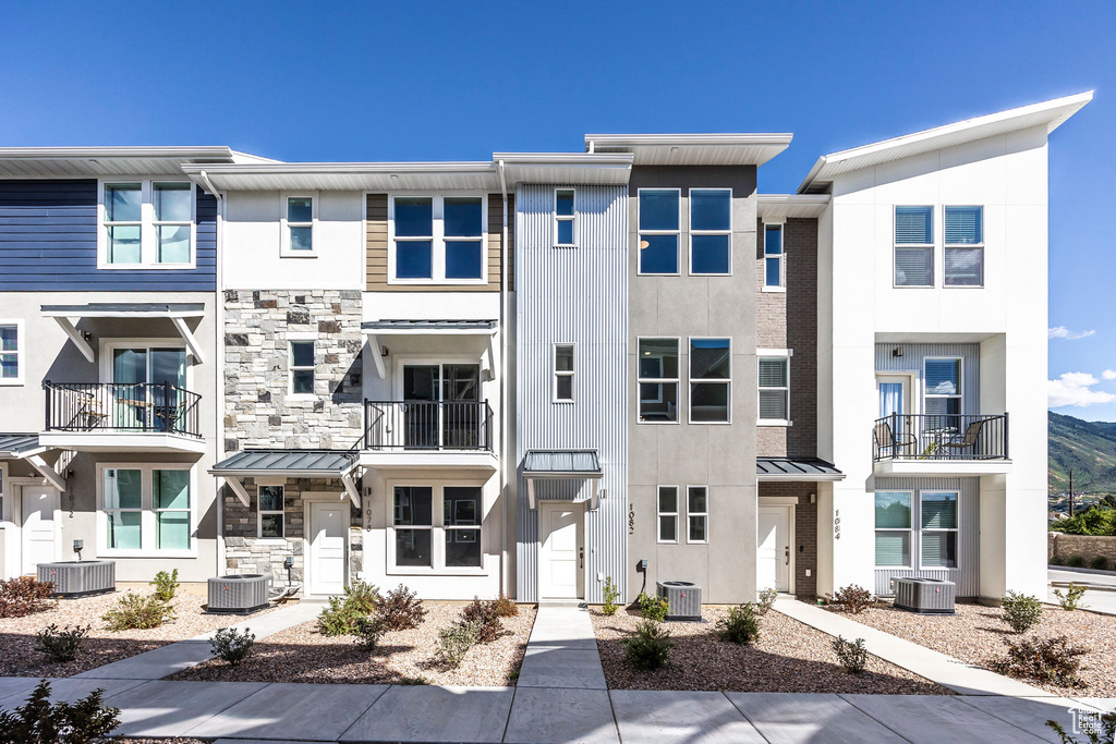 View of property featuring a balcony and central AC