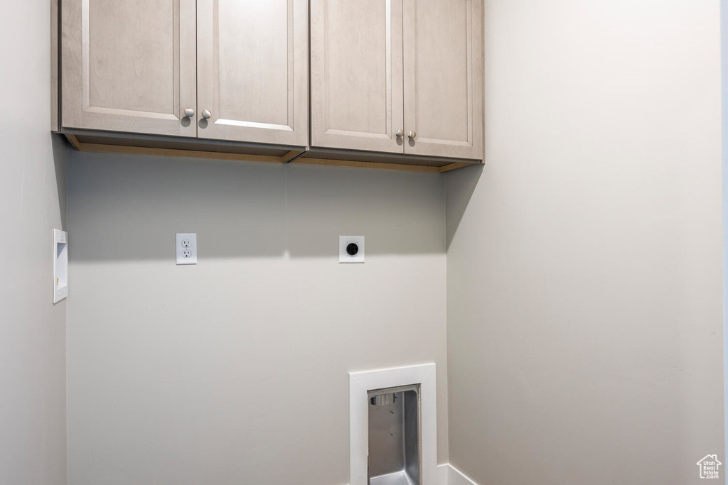 Laundry area with cabinets and electric dryer hookup