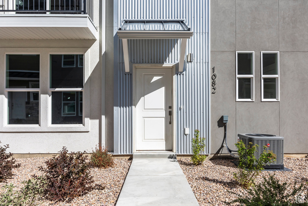 Doorway to property featuring central AC and a balcony