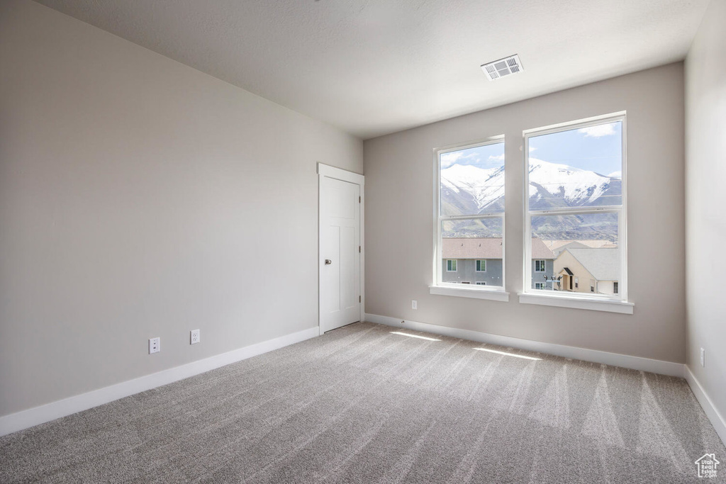 Spare room featuring carpet