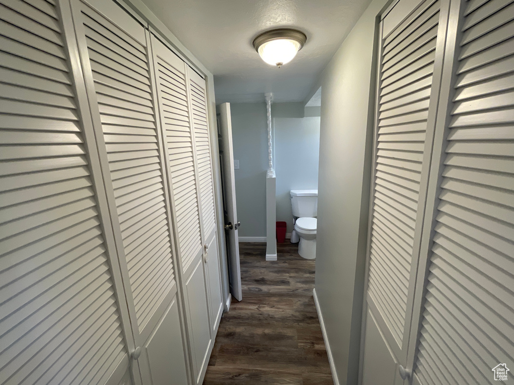 Hall with dark hardwood / wood-style flooring