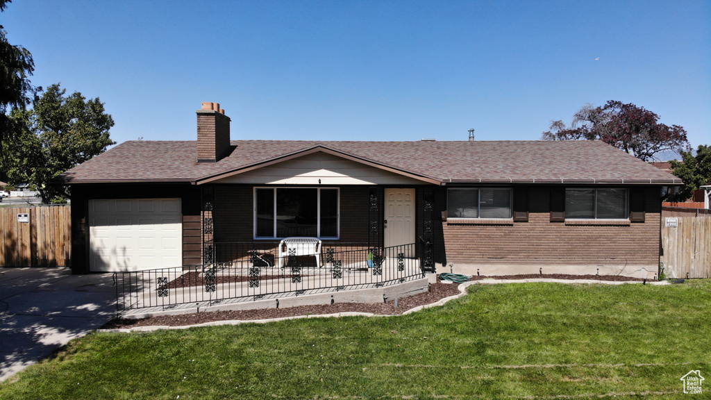 Ranch-style house with a garage and a front yard