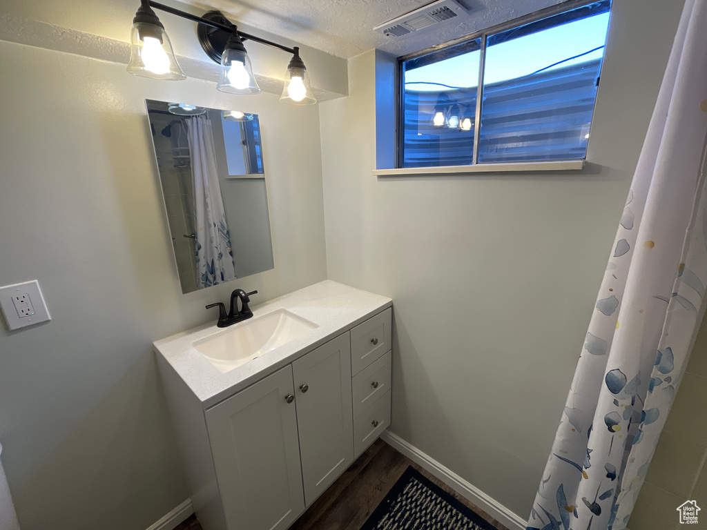 Bathroom featuring a textured ceiling and vanity