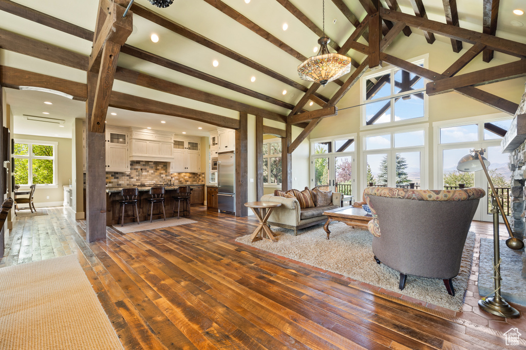 Living room with beam ceiling and dark hardwood / wood-style floors