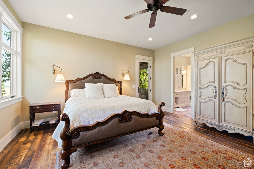 Bedroom with ensuite bath, dark hardwood / wood-style flooring, and ceiling fan