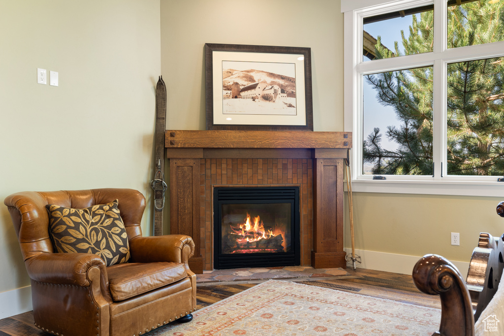 Sitting room with hardwood / wood-style flooring and a tiled fireplace