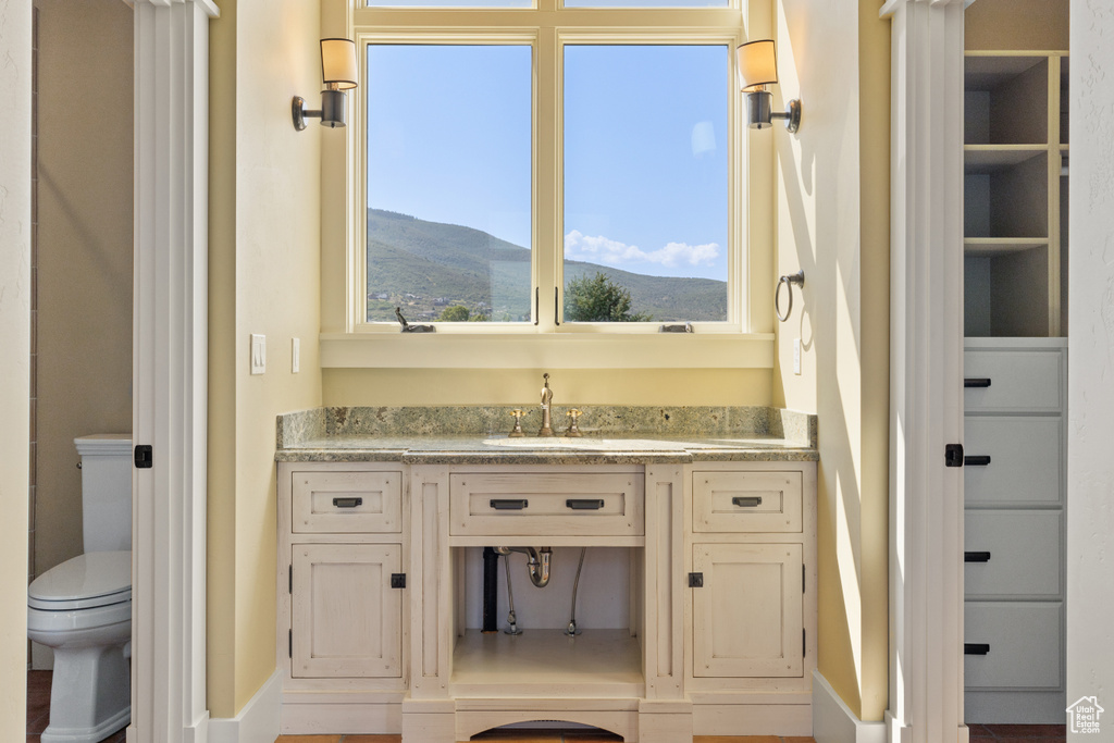 Bathroom featuring toilet, a mountain view, and vanity