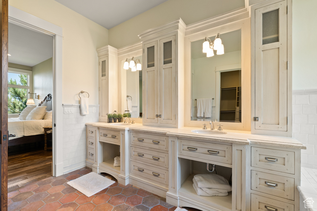 Bathroom with vanity, wood-type flooring, and a chandelier