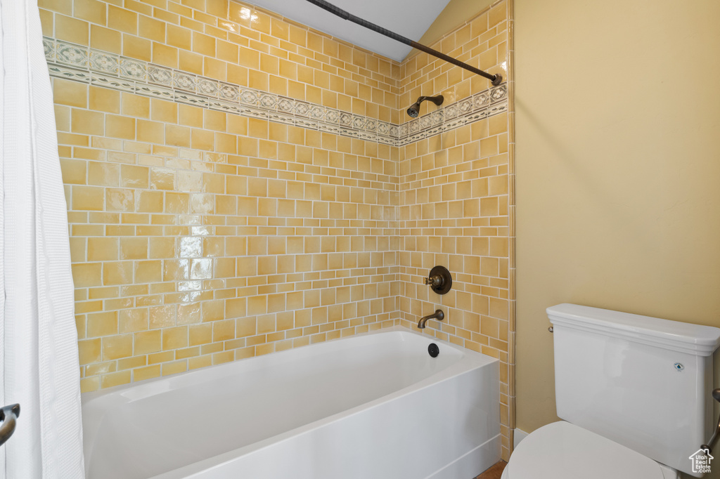 Bathroom featuring toilet and shower / tub combo