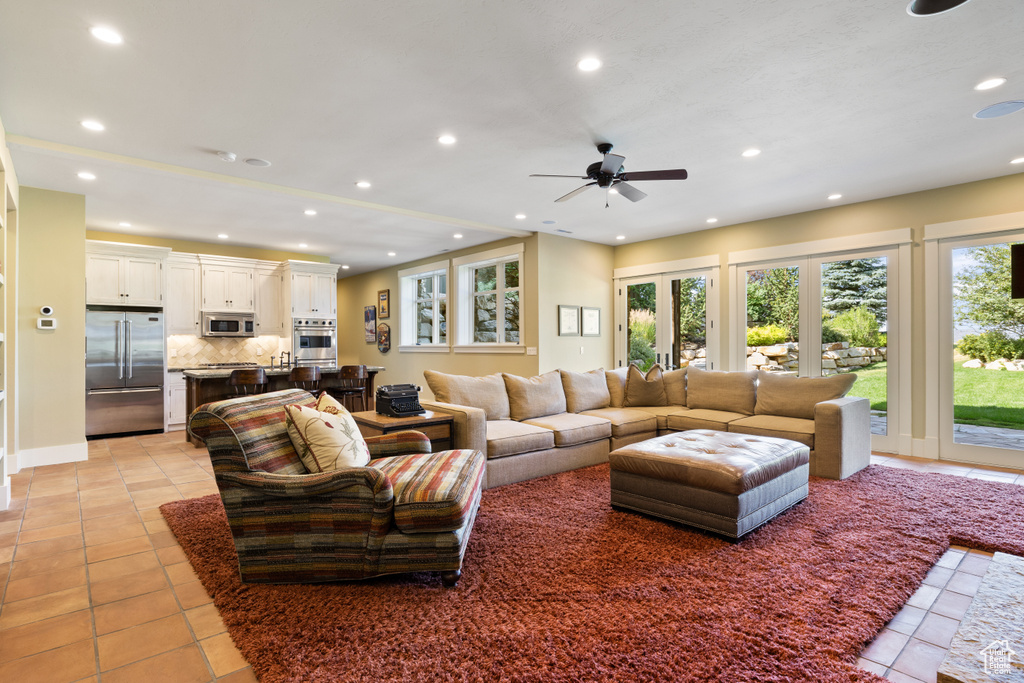 Tiled living room featuring ceiling fan