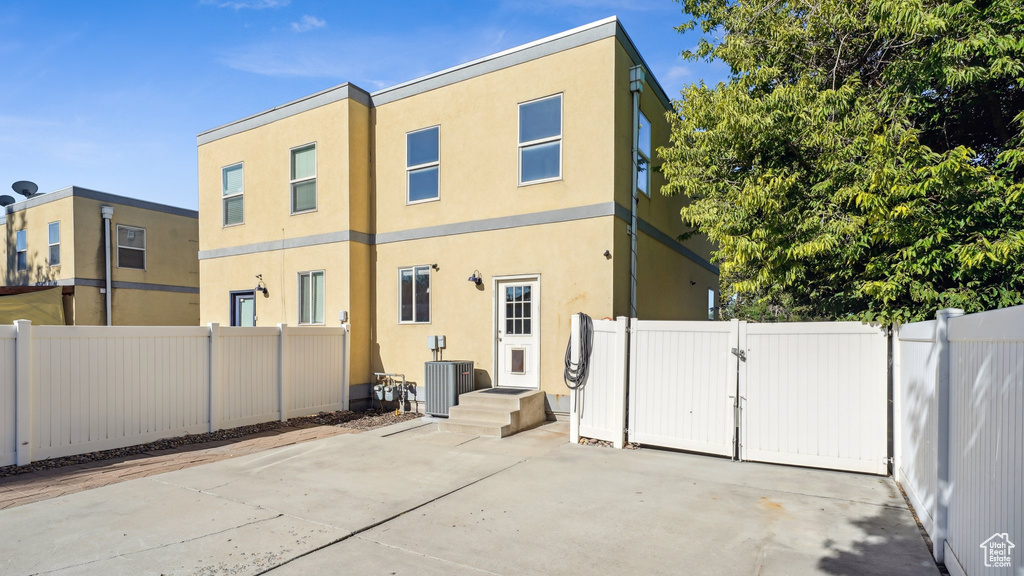 Rear view of property with central AC unit