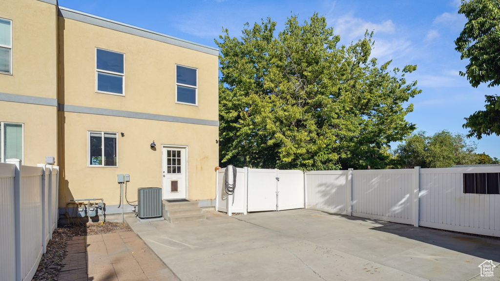 Rear view of house featuring cooling unit and a patio