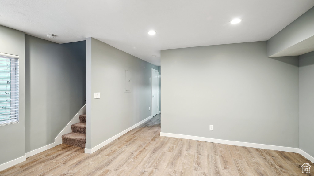 Basement with light wood-type flooring