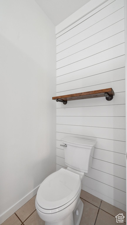 Bathroom featuring toilet and tile patterned flooring