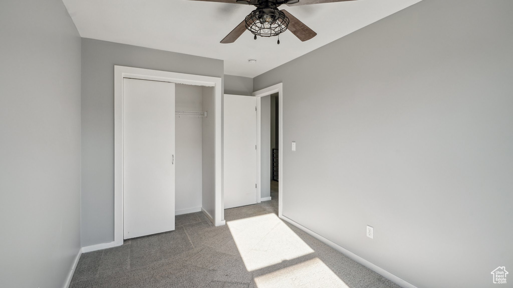 Unfurnished bedroom featuring a closet, ceiling fan, and carpet flooring