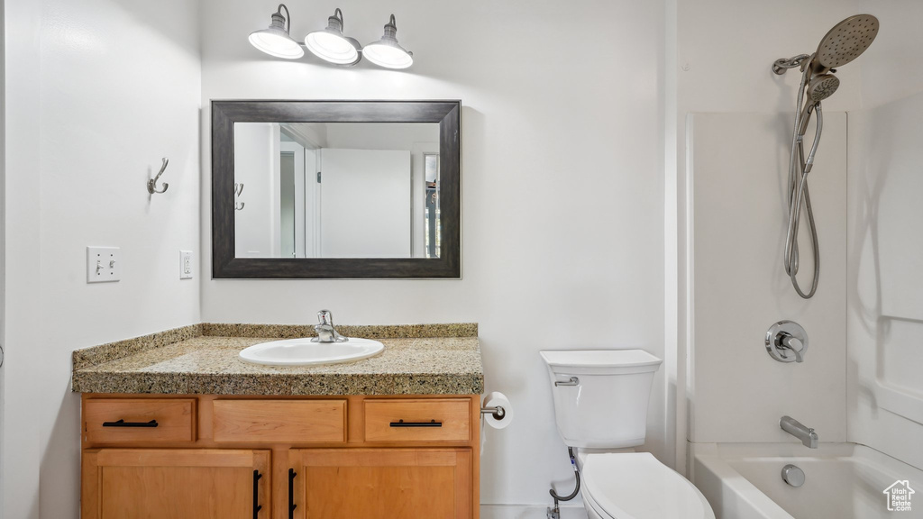 Full bathroom with vanity, toilet, and shower / washtub combination