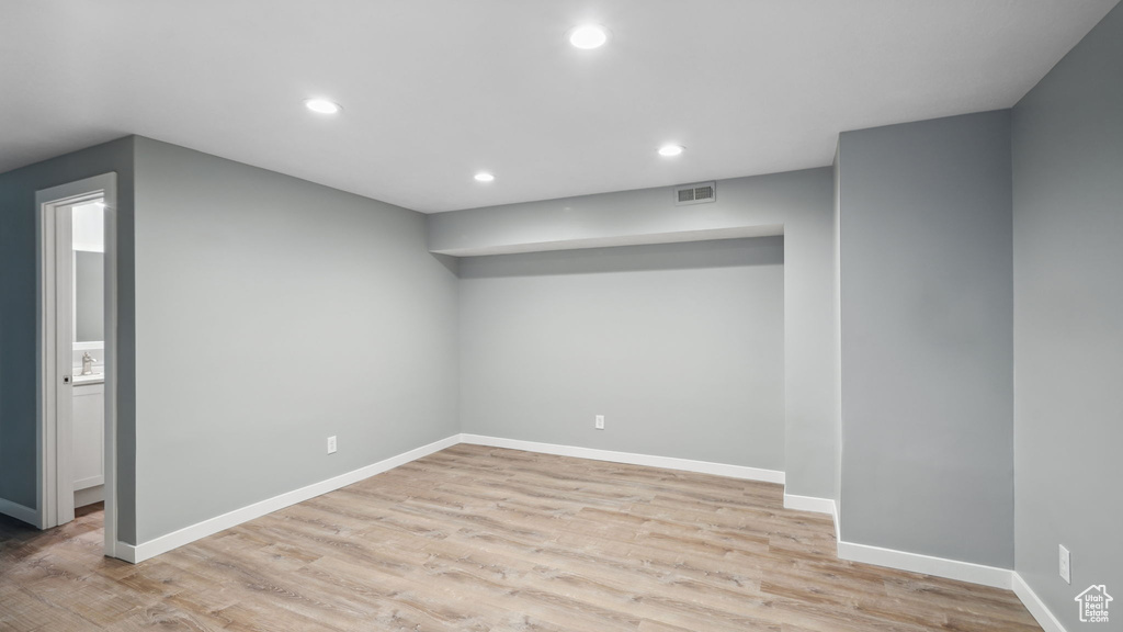 Empty room with light hardwood / wood-style floors