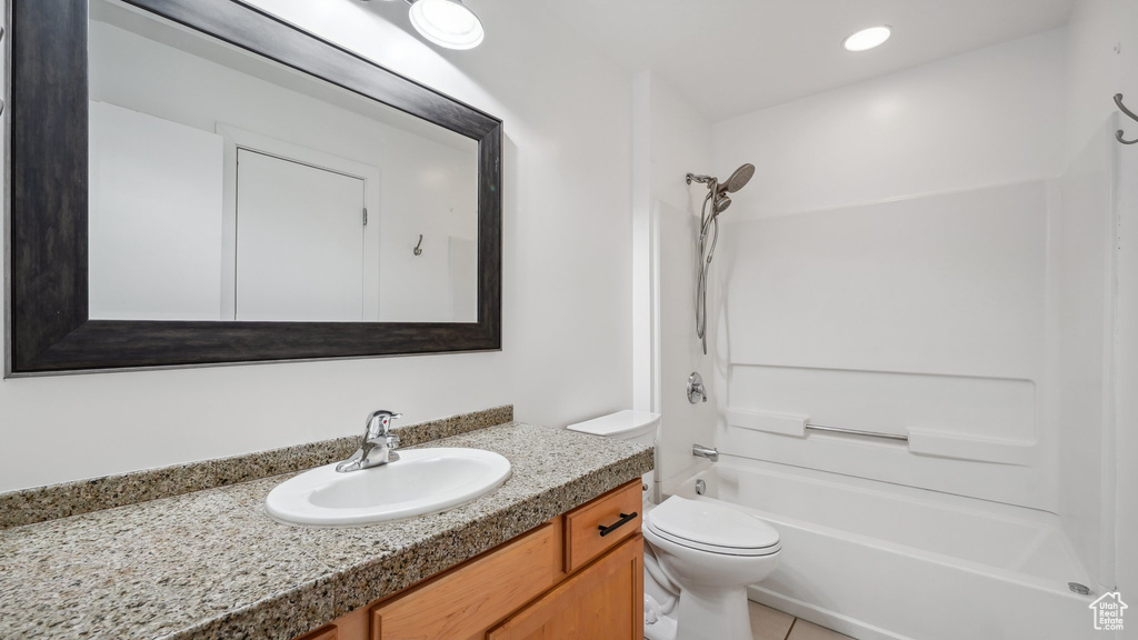 Full bathroom with tile patterned floors, shower / bath combination, toilet, and vanity