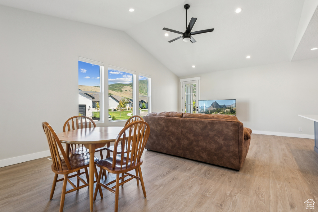 Dining area with lofted ceiling, light hardwood / wood-style flooring, and ceiling fan