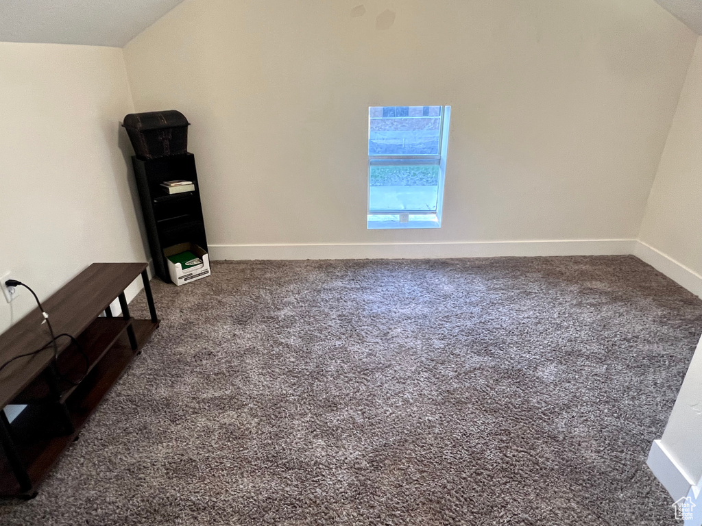 Interior space featuring baseboards and carpet floors