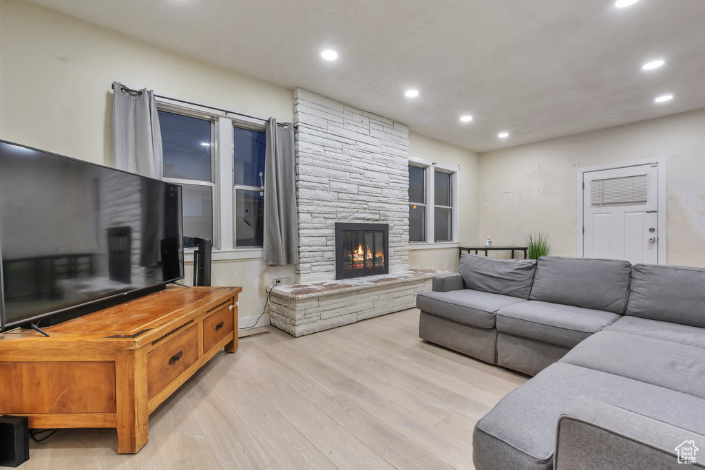 Living room with light wood-type flooring and a fireplace