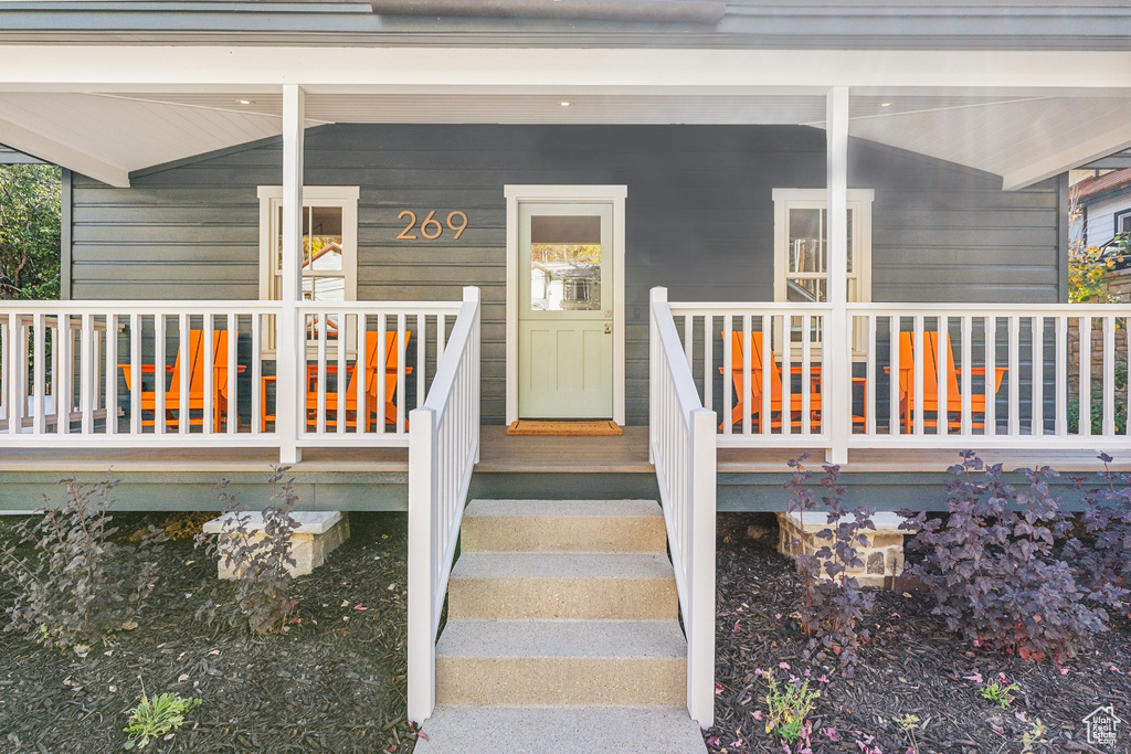 Entrance to property featuring covered porch