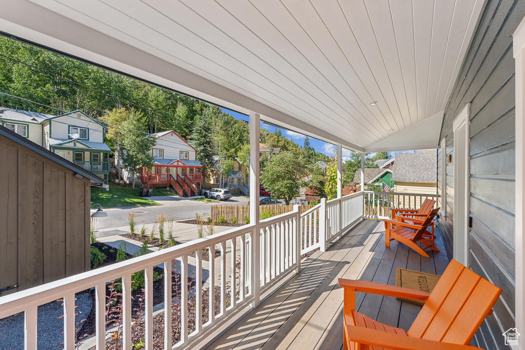 Wooden terrace featuring covered porch