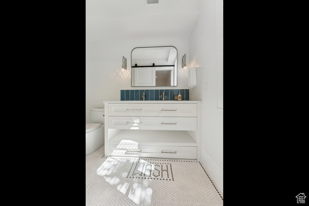 Bathroom with vanity, tile patterned flooring, and toilet