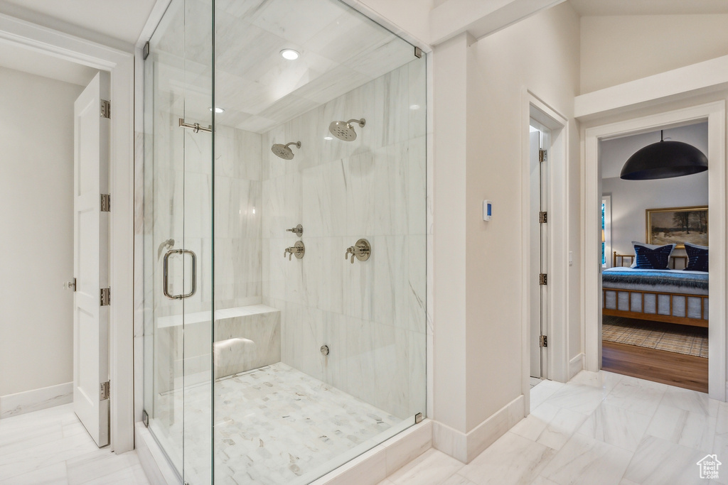 Bathroom featuring lofted ceiling and an enclosed shower