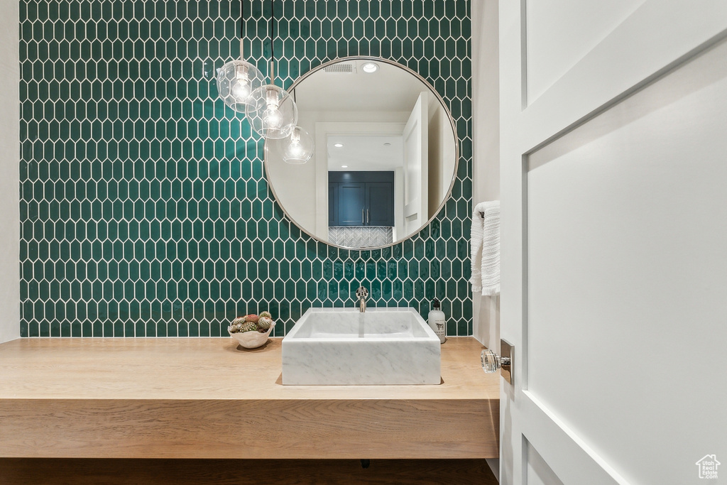 Bathroom with tile walls and vanity