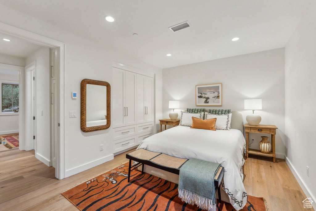 Bedroom with light wood-type flooring and a closet