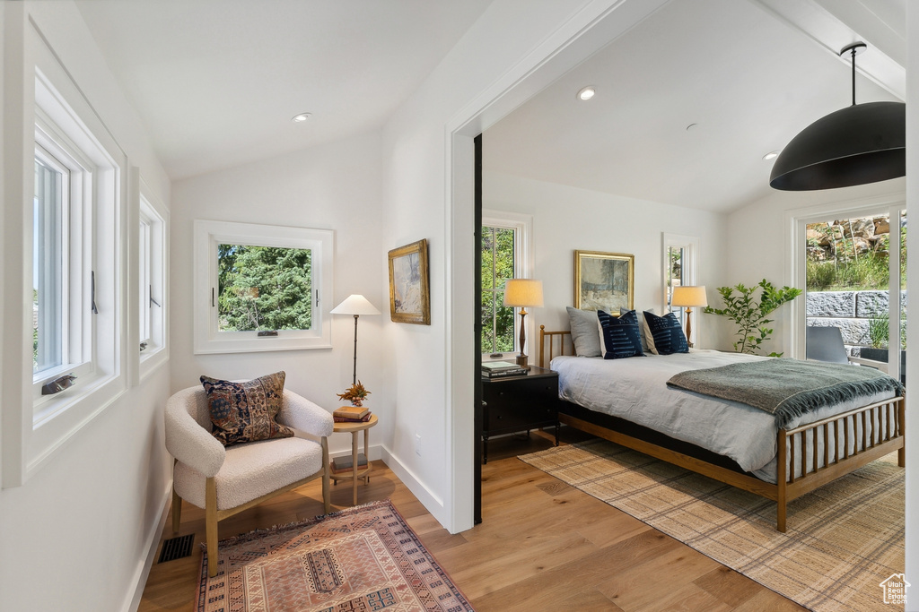 Bedroom featuring lofted ceiling with beams and wood-type flooring