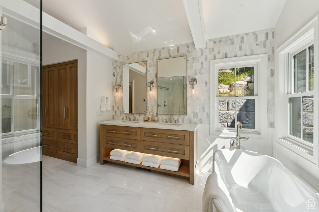 Bathroom with vaulted ceiling with beams, vanity, and shower with separate bathtub