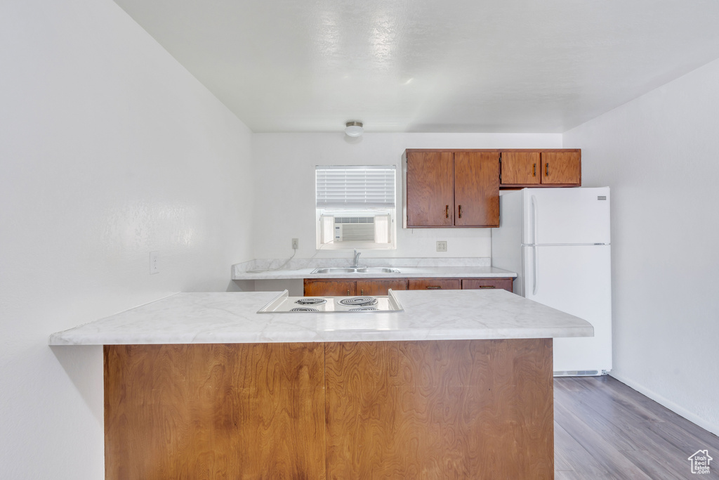 Kitchen featuring white appliances, sink, and dark hardwood / wood-style floors