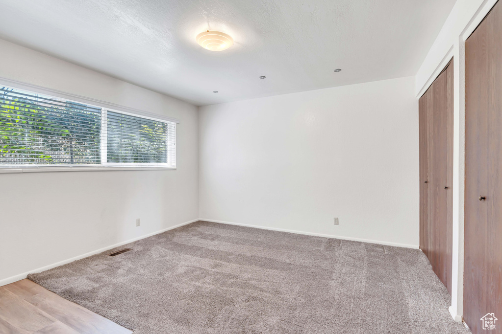 Unfurnished bedroom with carpet floors