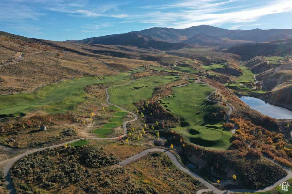 Drone / aerial view featuring a water and mountain view