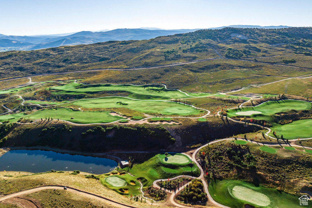 Birds eye view of property with a water and mountain view