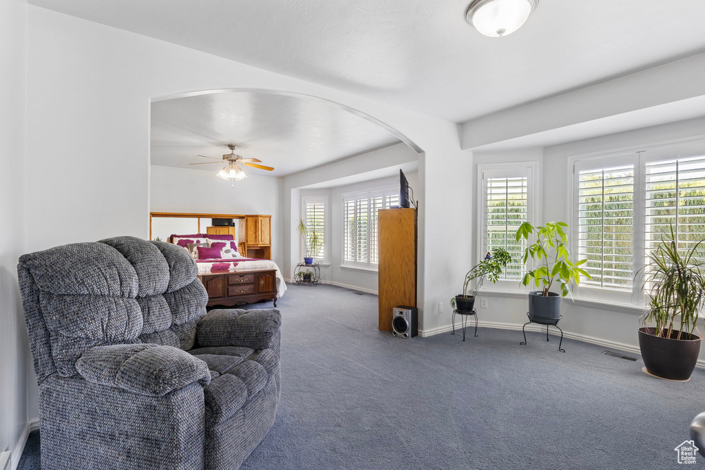 Living room featuring ceiling fan and carpet floors