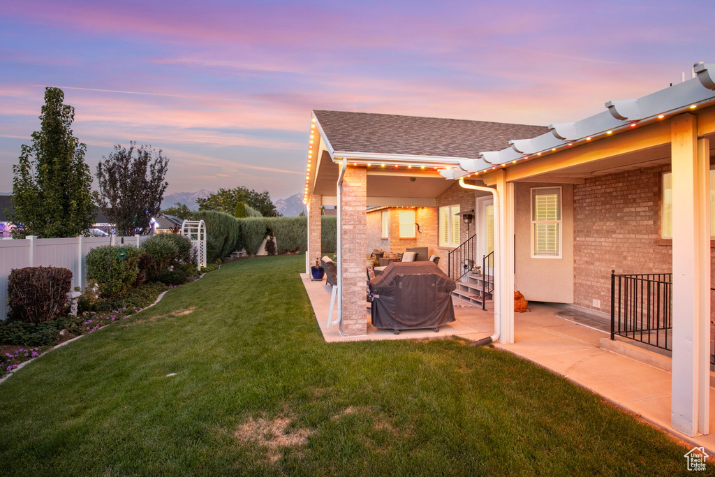 Yard at dusk with a patio area