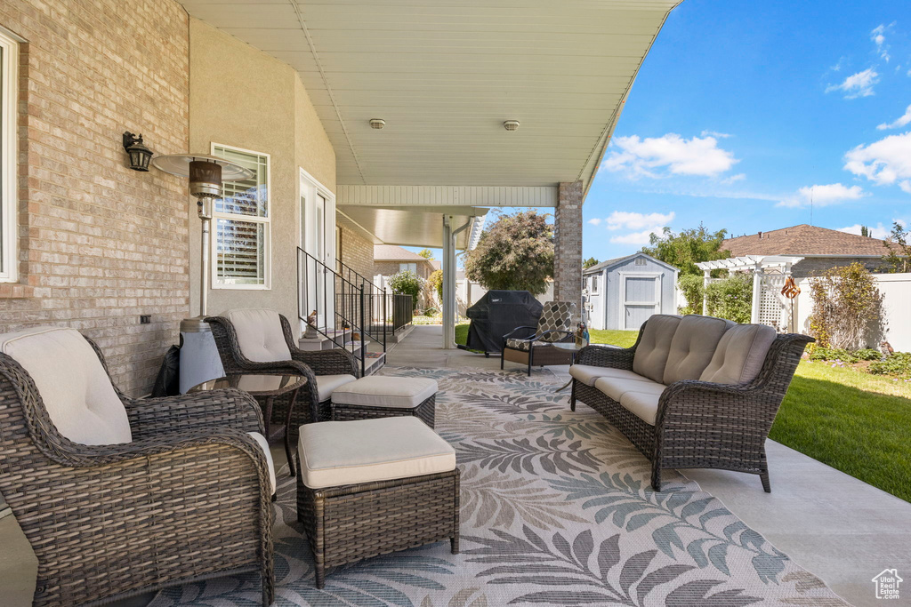 View of patio / terrace featuring grilling area, a storage shed, and an outdoor hangout area