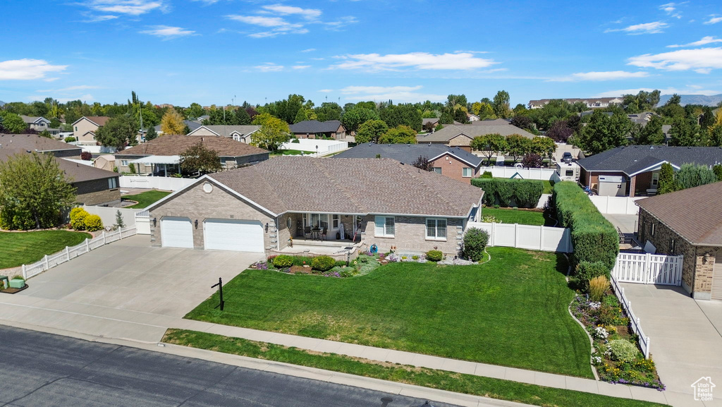 View of front of home featuring a front yard and a garage